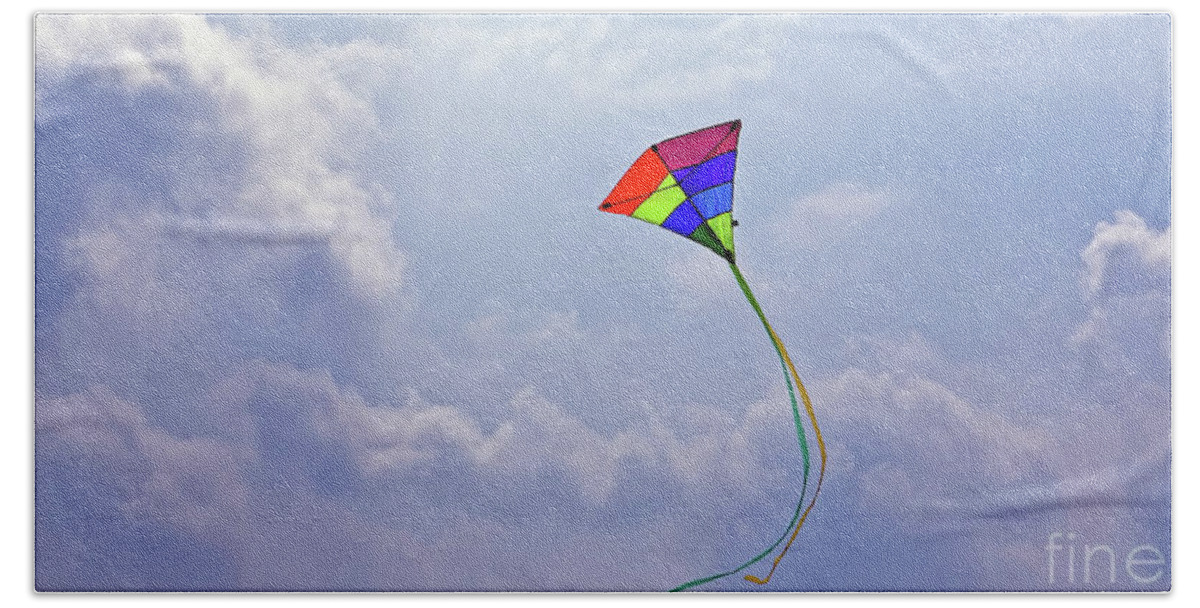 High Flying Swirling Kite Beach Towel featuring the photograph High Flying Multicolored Red Yellow Green Blue Purple Triangular Kite Flying Sunny Cloudy Blue Sky by Robert C Paulson Jr