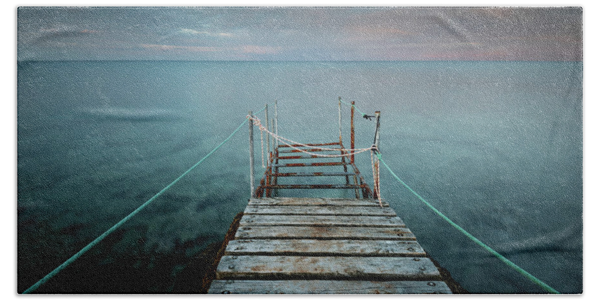 Tranquillity Beach Towel featuring the photograph Long wooden pier in the sea at sunset. #3 by Michalakis Ppalis