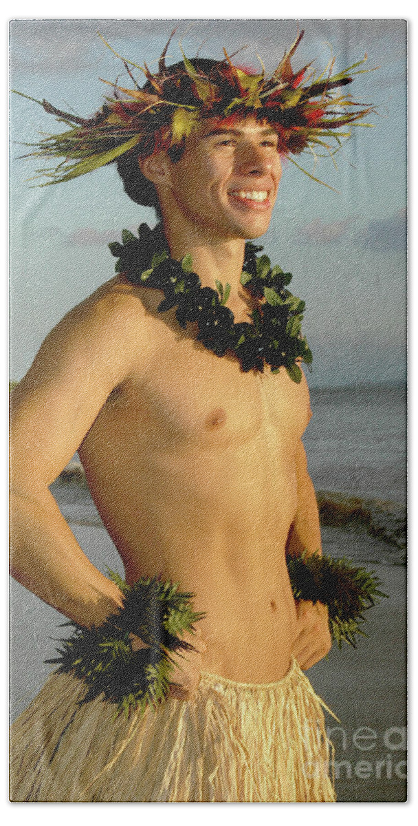 Male Hula Dancer Beach Towel featuring the photograph A smiling male hula dancer poses on the beach. by Gunther Allen