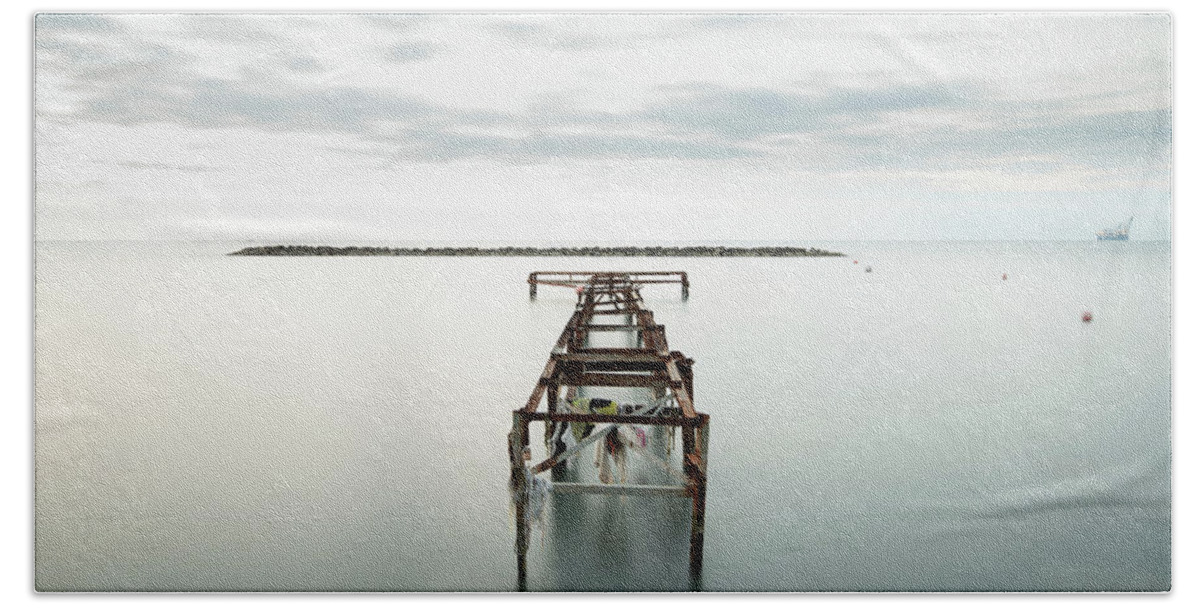 Jetty Beach Towel featuring the photograph Abandoned pier in the ocean. Long Exposure by Michalakis Ppalis