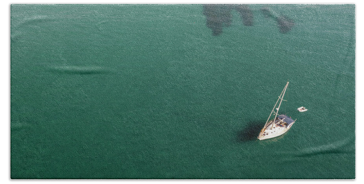 Anchored Beach Towel featuring the photograph Aerial view of a luxury yacht anchored in the surface of the sea. Cyprus vacations by Michalakis Ppalis