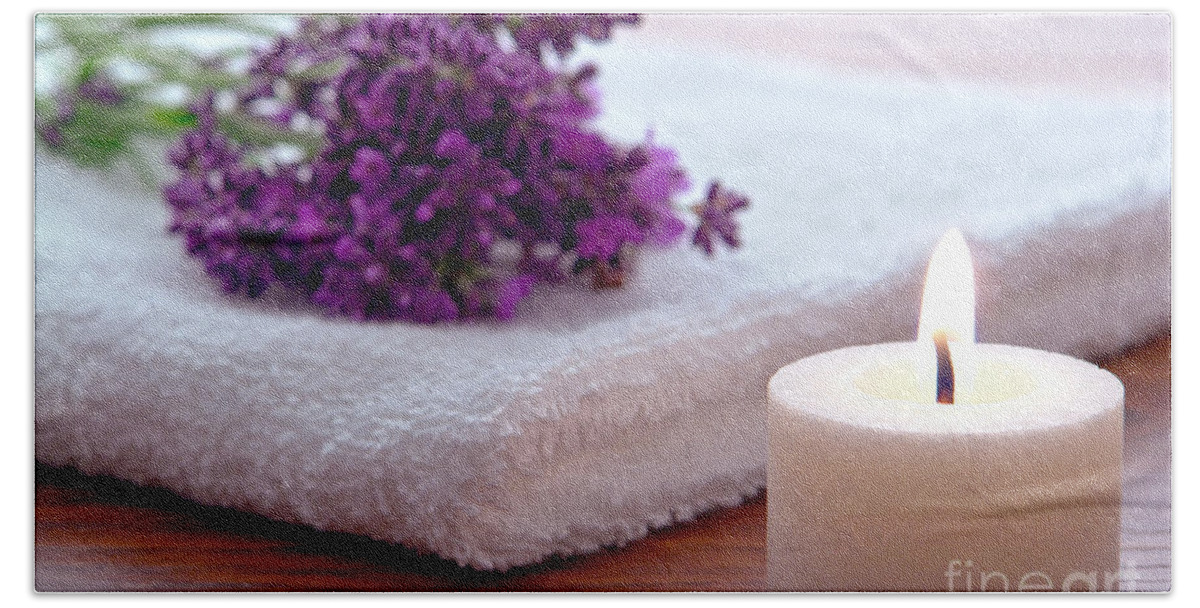 Aromatherapy Beach Towel featuring the photograph Aromatherapy Candle with Lavender Flowers on White Bath Towel in by Olivier Le Queinec
