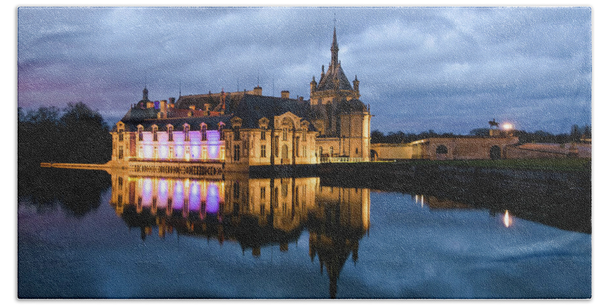 Ancient Beach Towel featuring the photograph Chantilly castle at night by Jean-Luc Farges