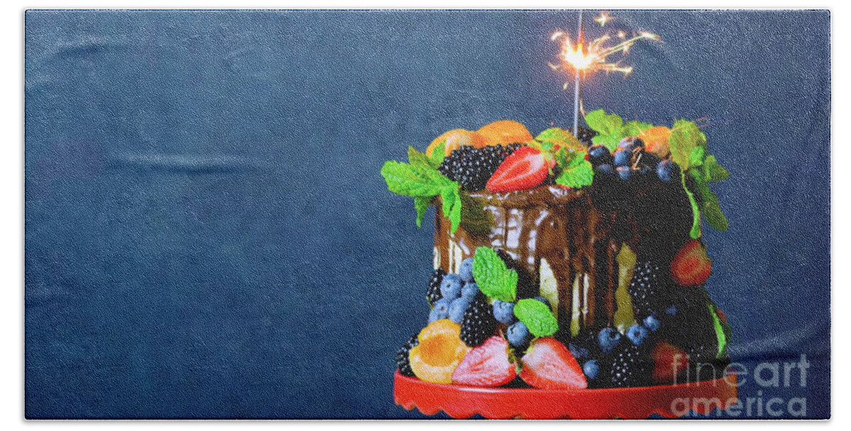 Birthday Beach Towel featuring the photograph Chocolate drip cake decorated with fresh fruit and berries with copy space. by Milleflore Images