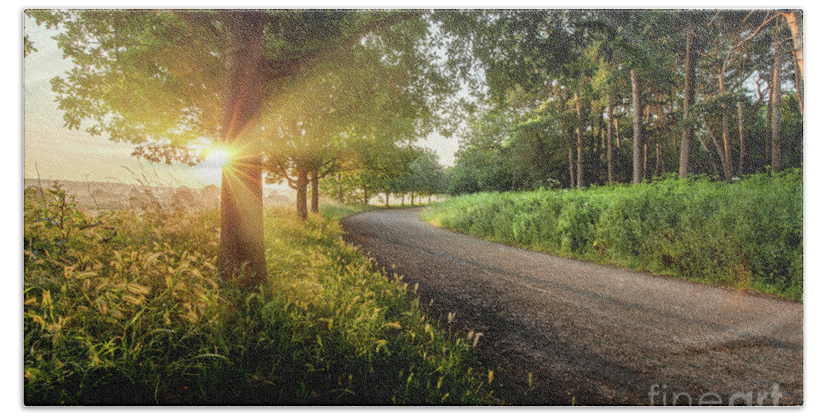 Sunrise Beach Towel featuring the photograph Dawn sunrise along a Norfolk rural road with trees by Simon Bratt