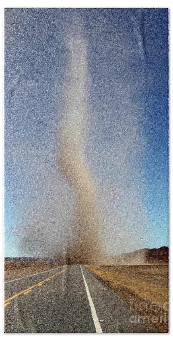 Dust Devil Beach Sheet featuring the photograph Dust devil crossing the road Bolivia by James Brunker