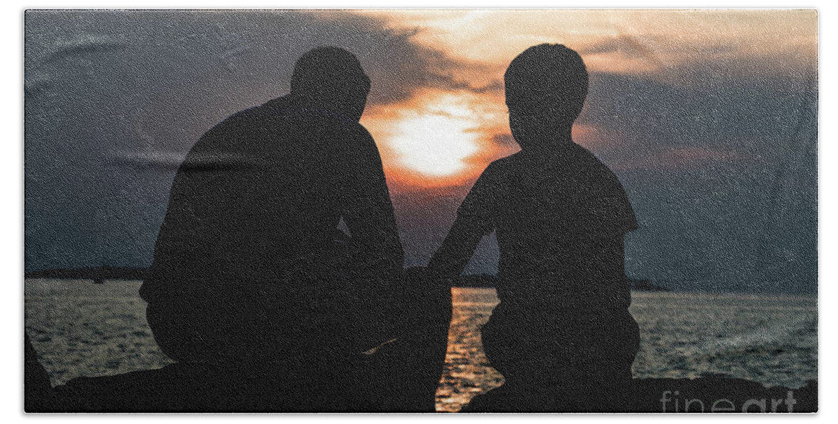 Adult Beach Towel featuring the photograph Father And Son Talking While Sitting On Stones At The Coast During Sunset by Andreas Berthold