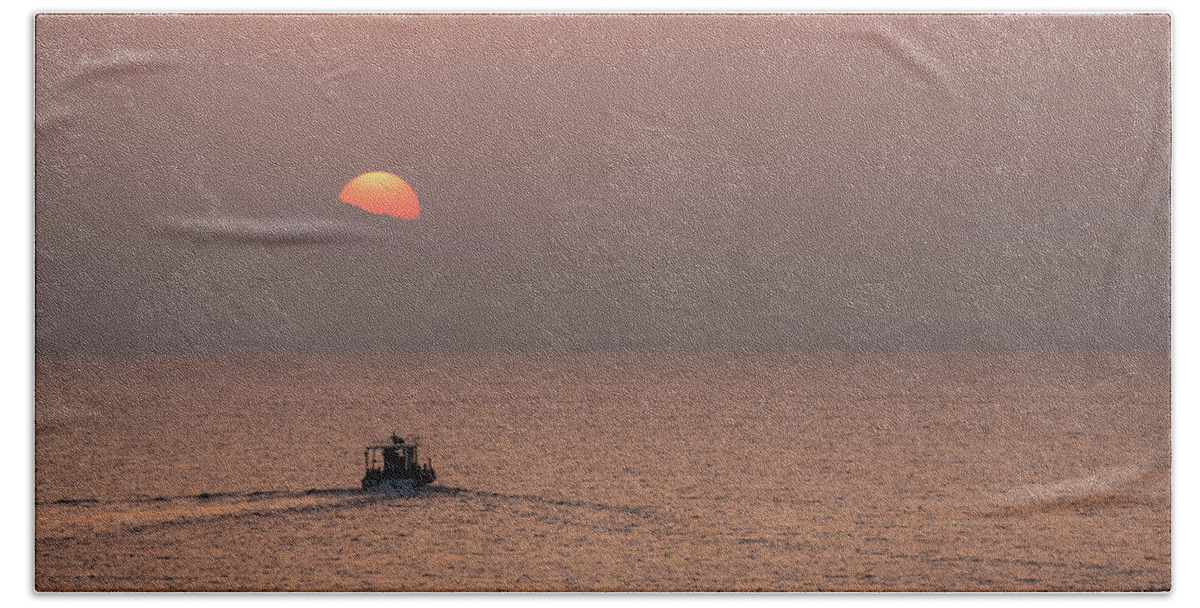 Sunset Beach Towel featuring the photograph Fishing boat sailing in the sea to catch fish at sunset by Michalakis Ppalis