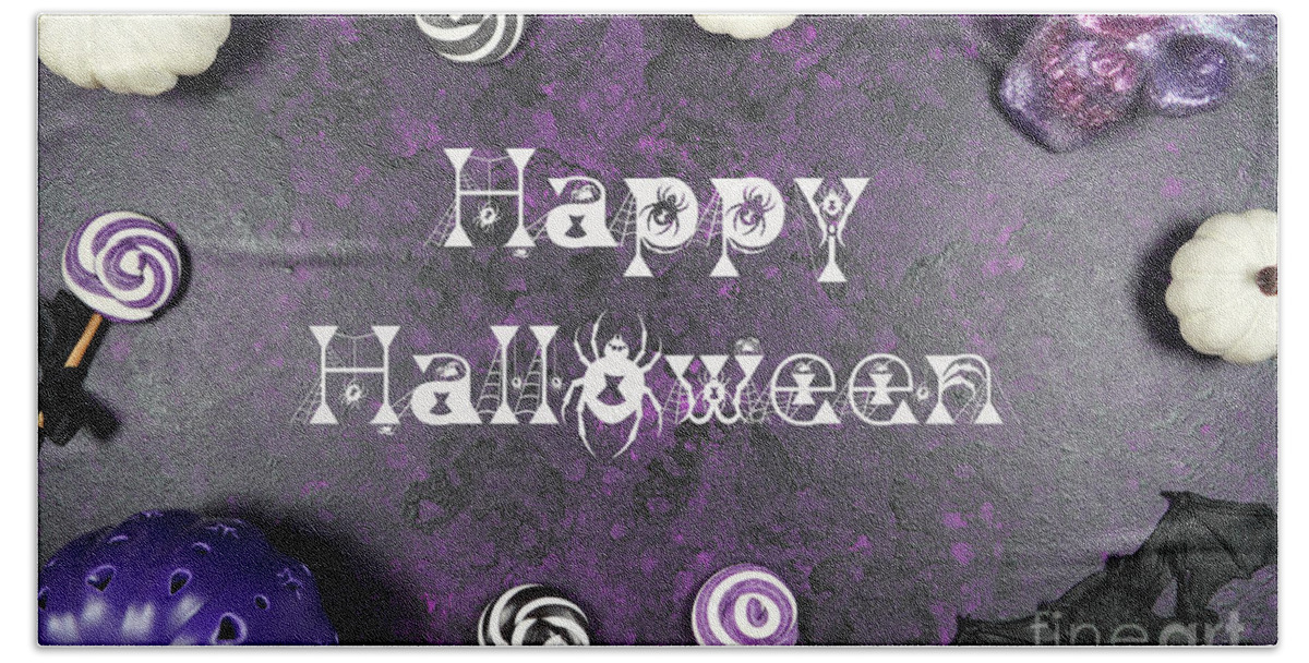 Halloween Beach Towel featuring the photograph Halloween trick or treat flatlay on purple background with white by Milleflore Images