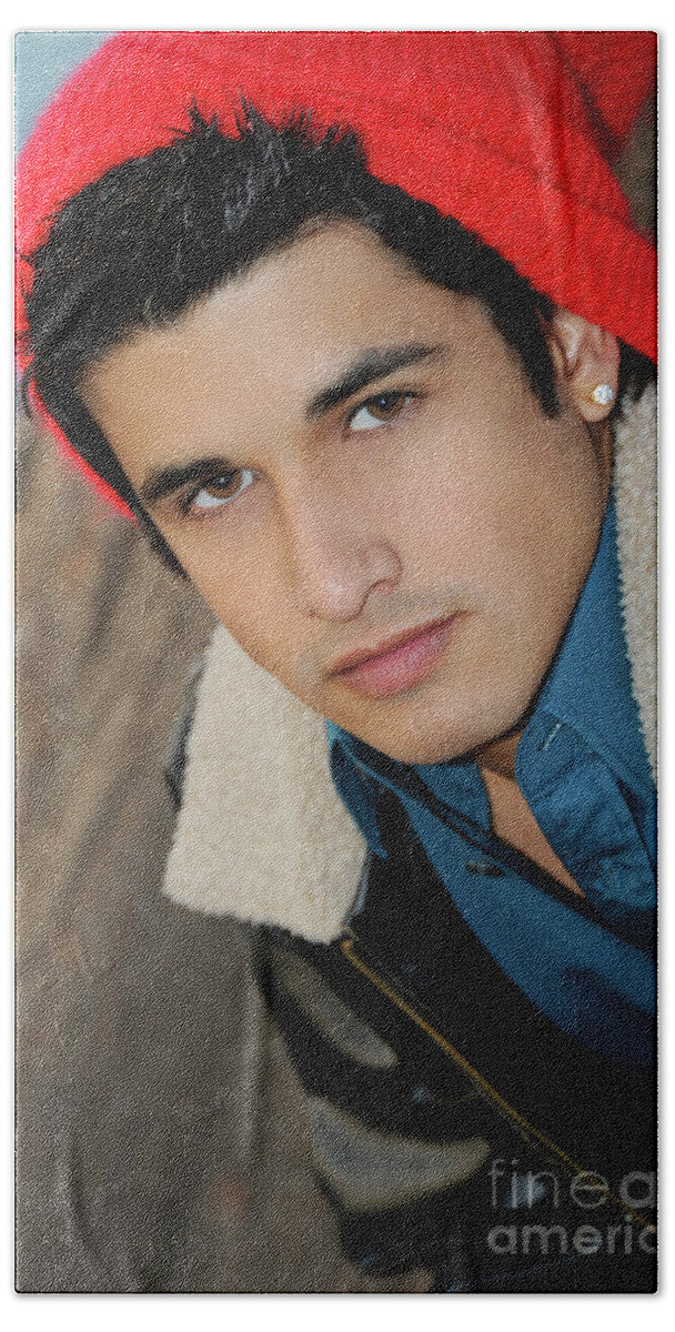 Face Beach Towel featuring the photograph Handsome young hispanic man portrait wearing a red ski cap by Gunther Allen