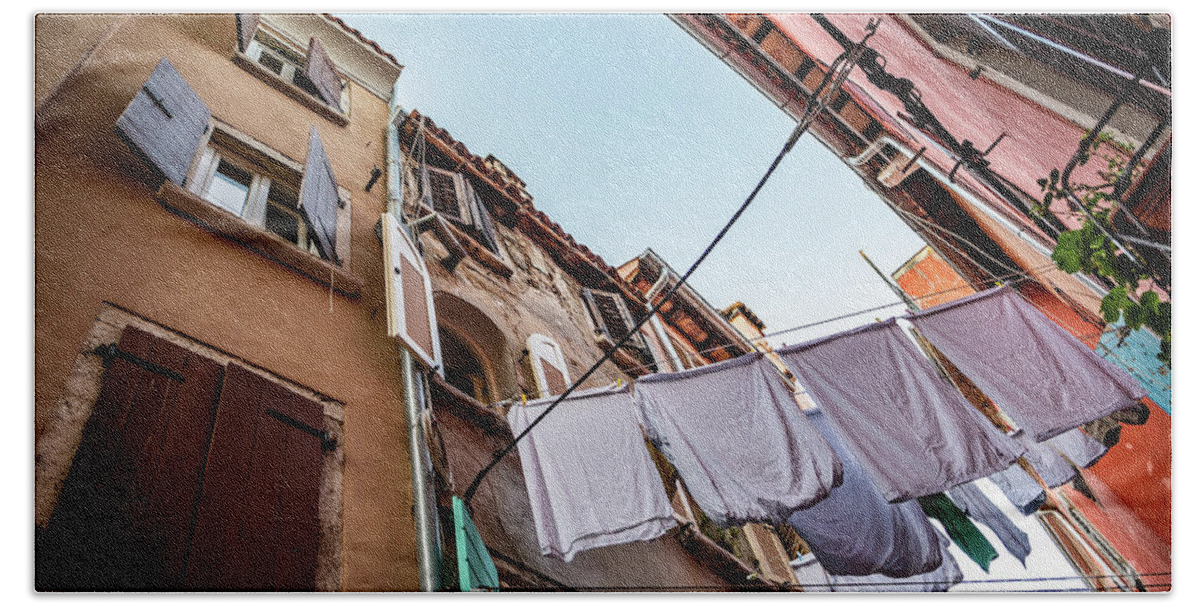 Croatia Beach Towel featuring the photograph Narrow Alley With Old Houses And Freshly Washed Laundry In The City Of Rovinj In Croatia by Andreas Berthold