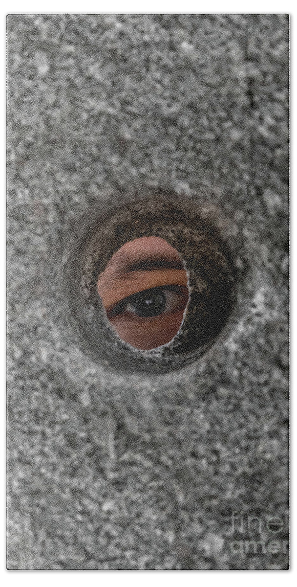 Anxiety Beach Towel featuring the photograph Open Eye Looking Through Round Hole In Stone Wall by Andreas Berthold