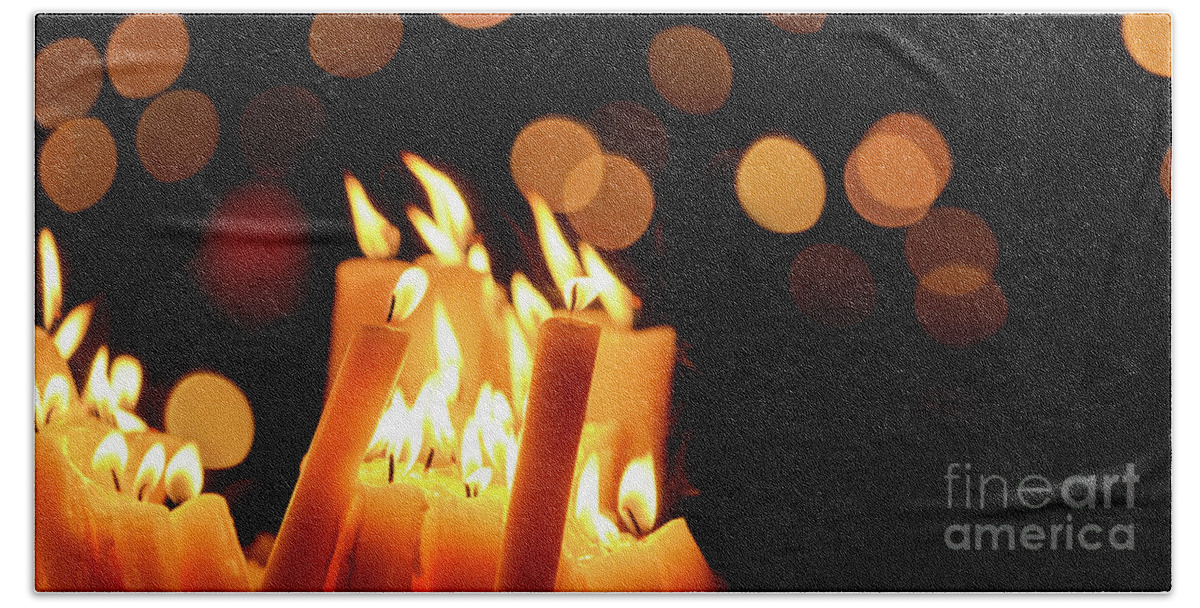 Candle Beach Towel featuring the photograph Religious candles in front of bokeh light by Jelena Jovanovic