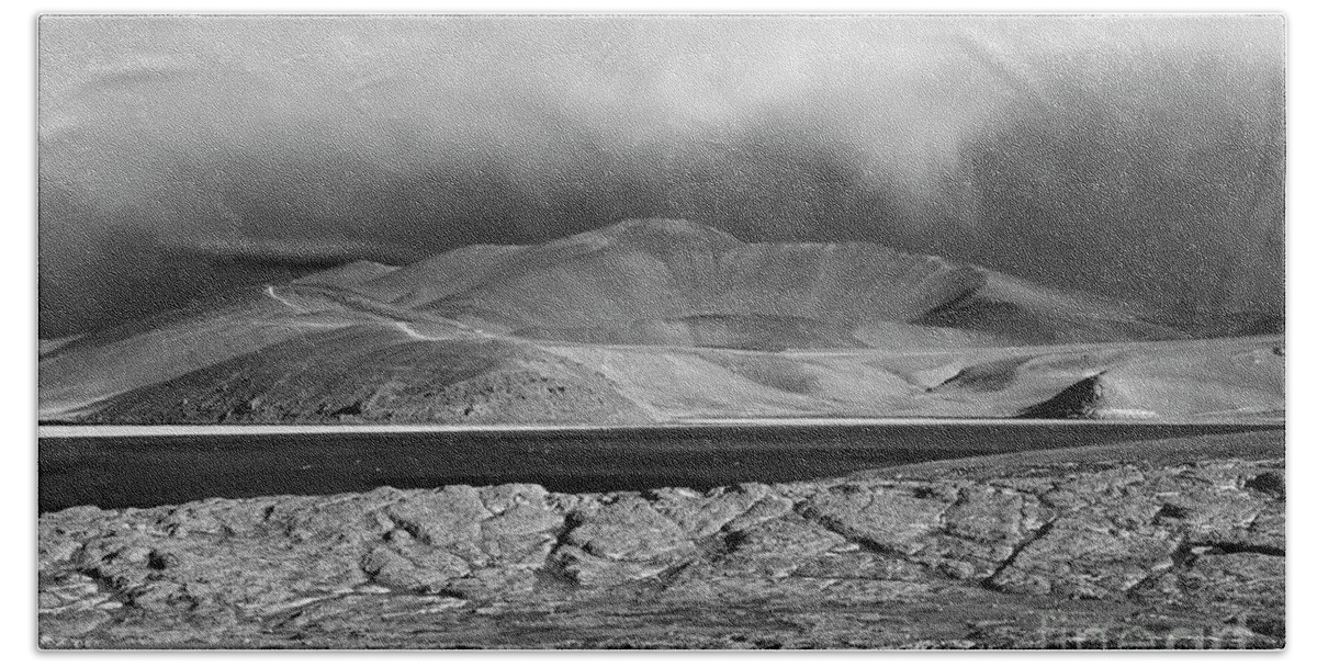 Chile Beach Towel featuring the photograph Rocks storm clouds and Laguna Santa Rosa monochrome Chile by James Brunker