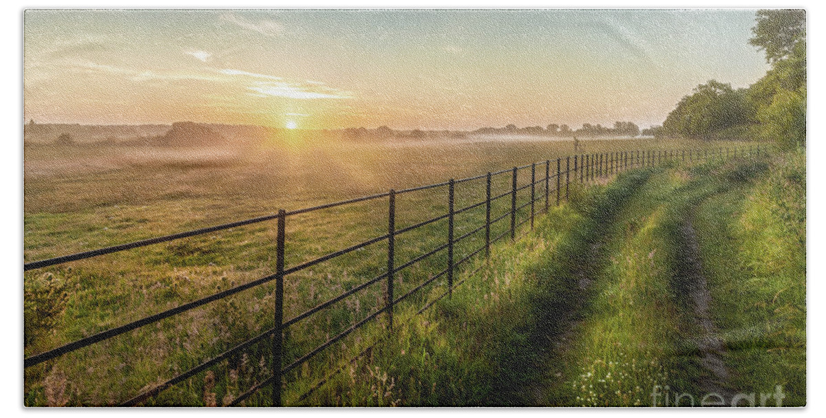 Norfolk Beach Towel featuring the photograph Sunrise over rural fields fences and track in Norfolk UK by Simon Bratt