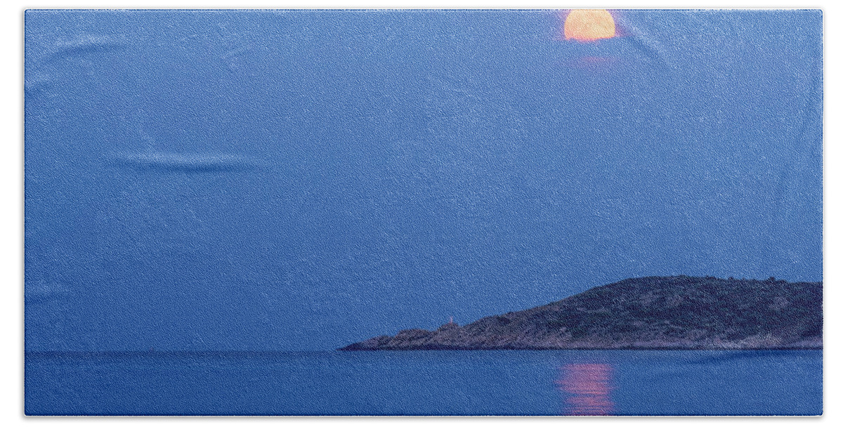 Moon Beach Towel featuring the photograph Supermoon rising behind clouds above the sea by Alexios Ntounas