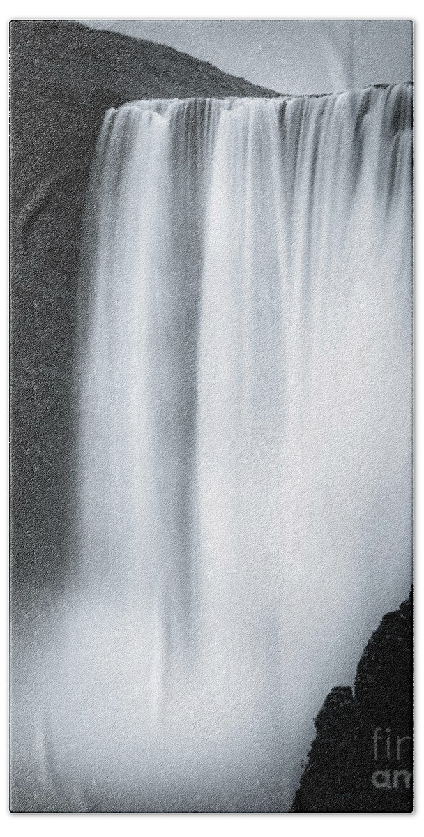 Attraction Beach Towel featuring the photograph The Skogafoss in Black and White by Henk Meijer Photography