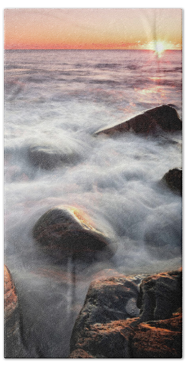 New Hampshire Beach Towel featuring the photograph Wet Rocks In The Surf At Sunrise. by Jeff Sinon