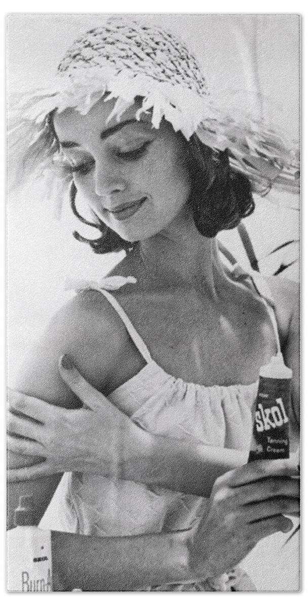  Beach Sheet featuring the photograph Young Woman Applies Tanning Cream by Underwood Archives