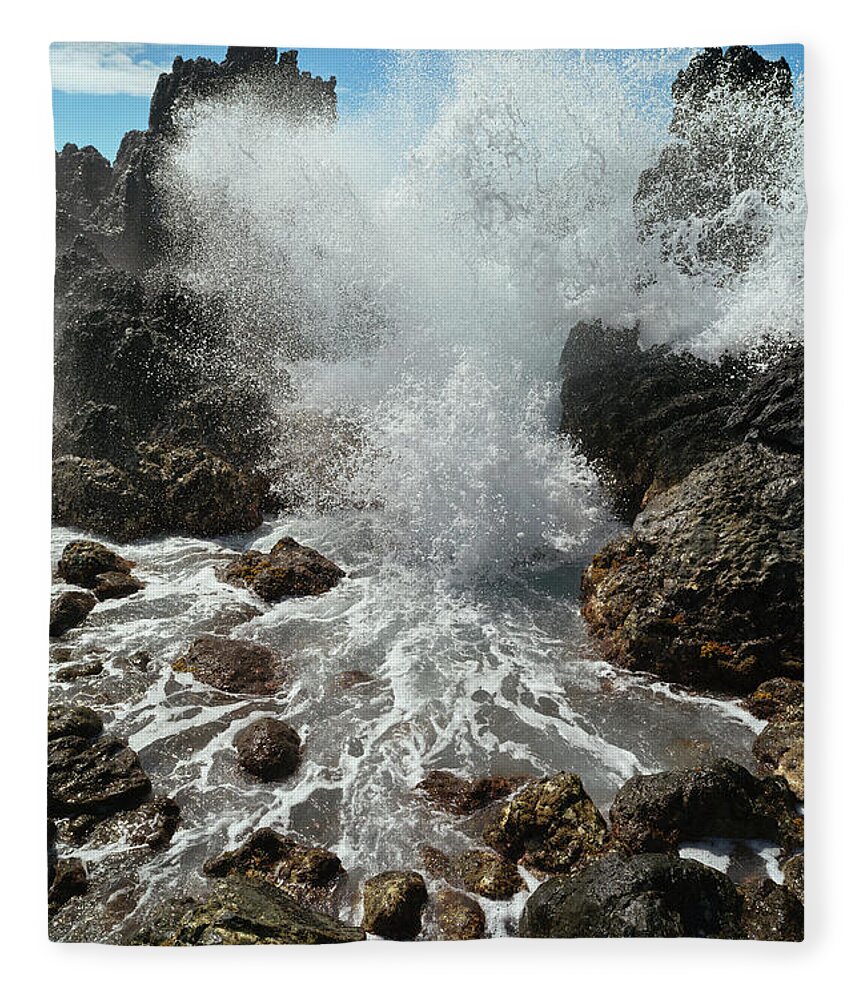 Extreme Terrain Fleece Blanket featuring the photograph A Wave Crashing And Splashing Against by Philip Rosenberg / Design Pics