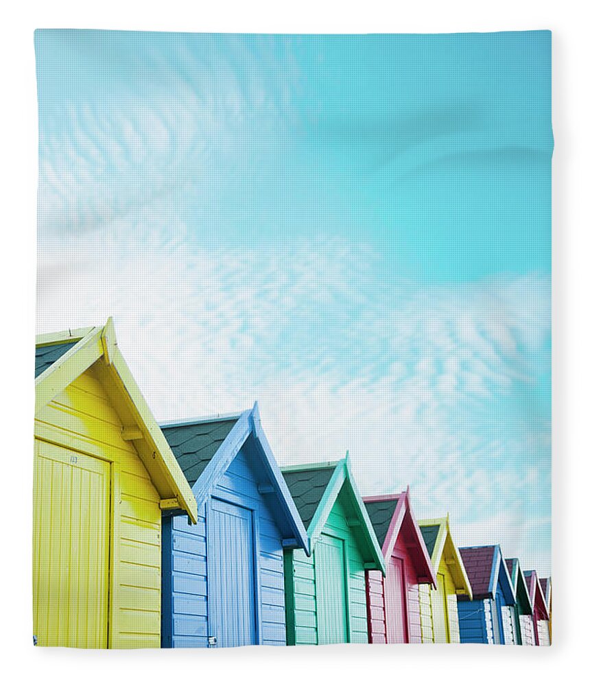 Beach Hut Fleece Blanket featuring the photograph Colourful Beach Huts Along The Seafront by Andrew Bret Wallis