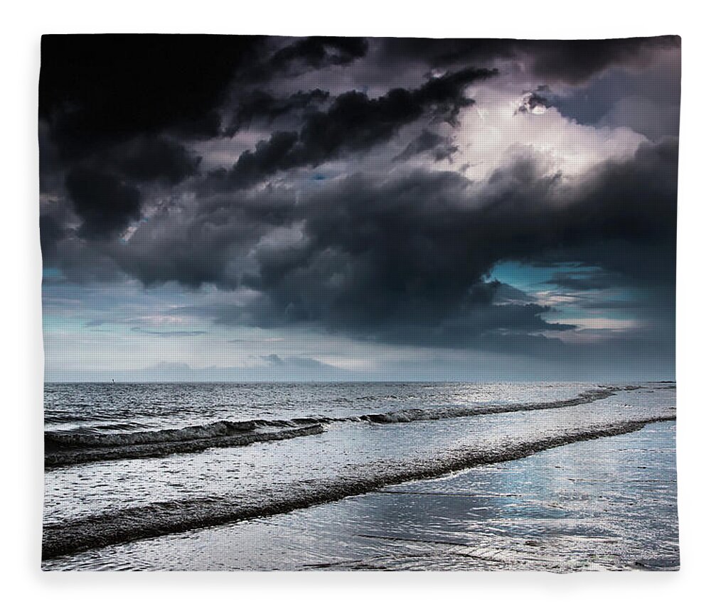 Tide Fleece Blanket featuring the photograph Dark Storm Clouds Over The Ocean With by John Short / Design Pics