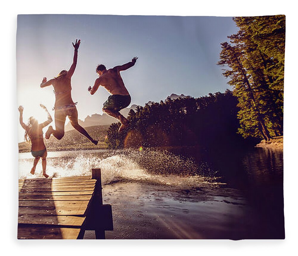 Child Fleece Blanket featuring the photograph Jumping Into The Water From A Jetty by Wundervisuals