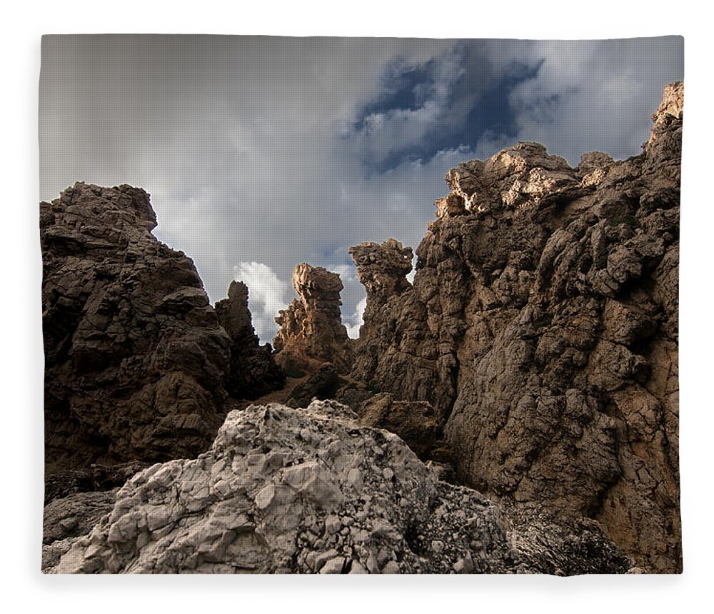 Autumn Fleece Blanket featuring the photograph A stunning rock wall becomes a wild nature sculpture in north coast of Minorca Europe by Pedro Cardona Llambias