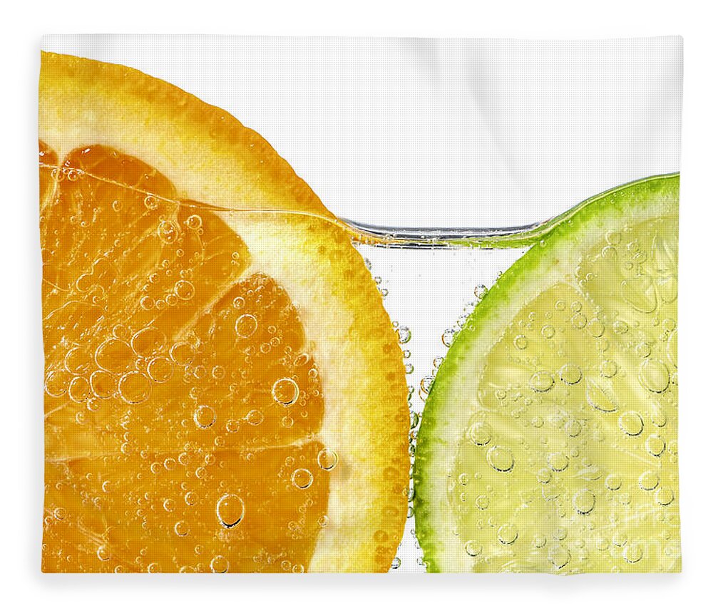 Orange Fleece Blanket featuring the photograph Orange and lime slices in water by Elena Elisseeva