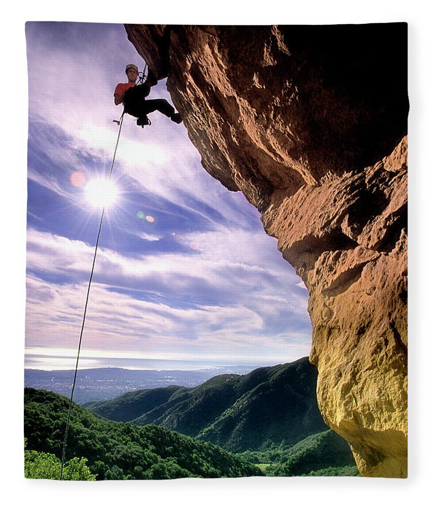30s Fleece Blanket featuring the photograph Silhouetted Climber Rapelling by Kevin Steele