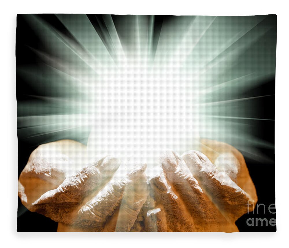 Spiritual Fleece Blanket featuring the photograph Spiritual light in cupped hands on a black background by Simon Bratt