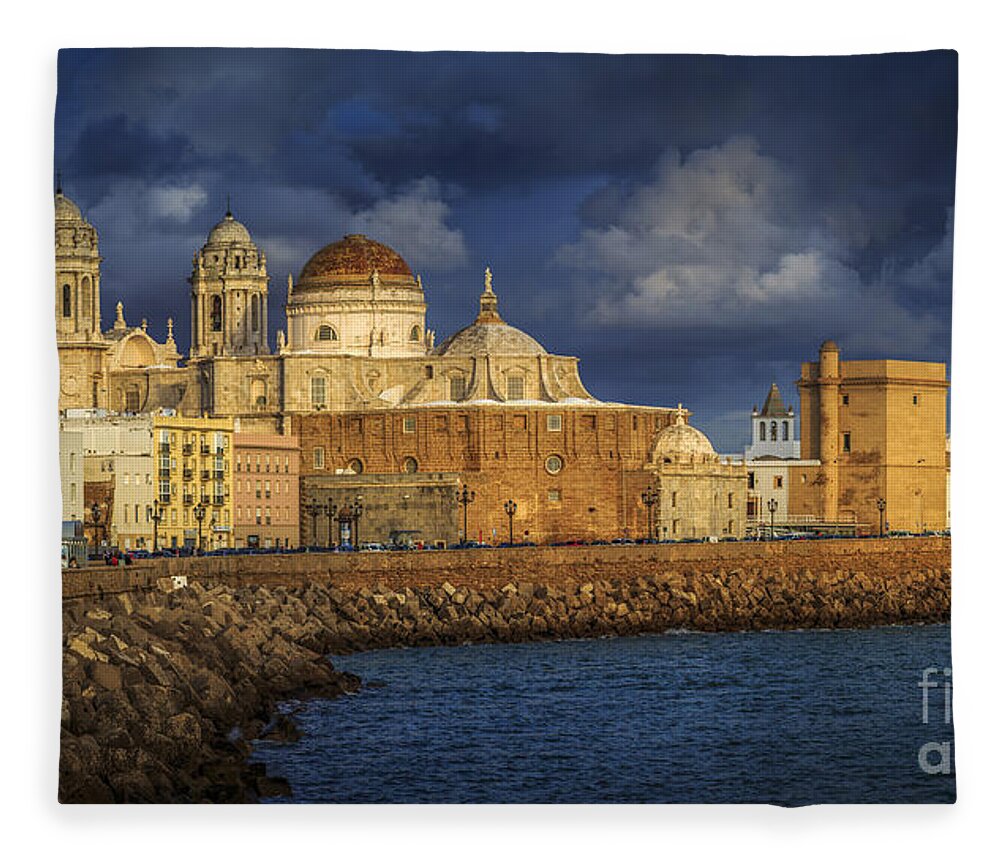 Andalucia Fleece Blanket featuring the photograph Stormy Skies Over the Cathedral Cadiz spain by Pablo Avanzini