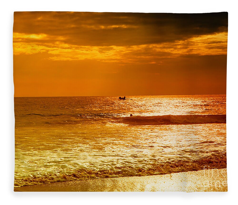 Sunset Fleece Blanket featuring the photograph sunset in gold and red at the Hikkaduwa beach by Gina Koch