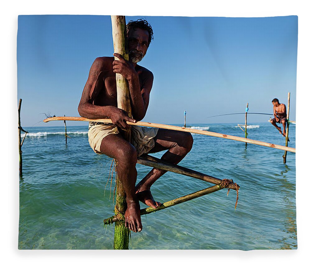 Working Fleece Blanket featuring the photograph The Stilt Fishermen At Work, Sri Lanka by Hadynyah