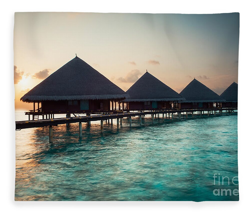 Amazing Fleece Blanket featuring the photograph Waterbungalows At Sunset by Hannes Cmarits