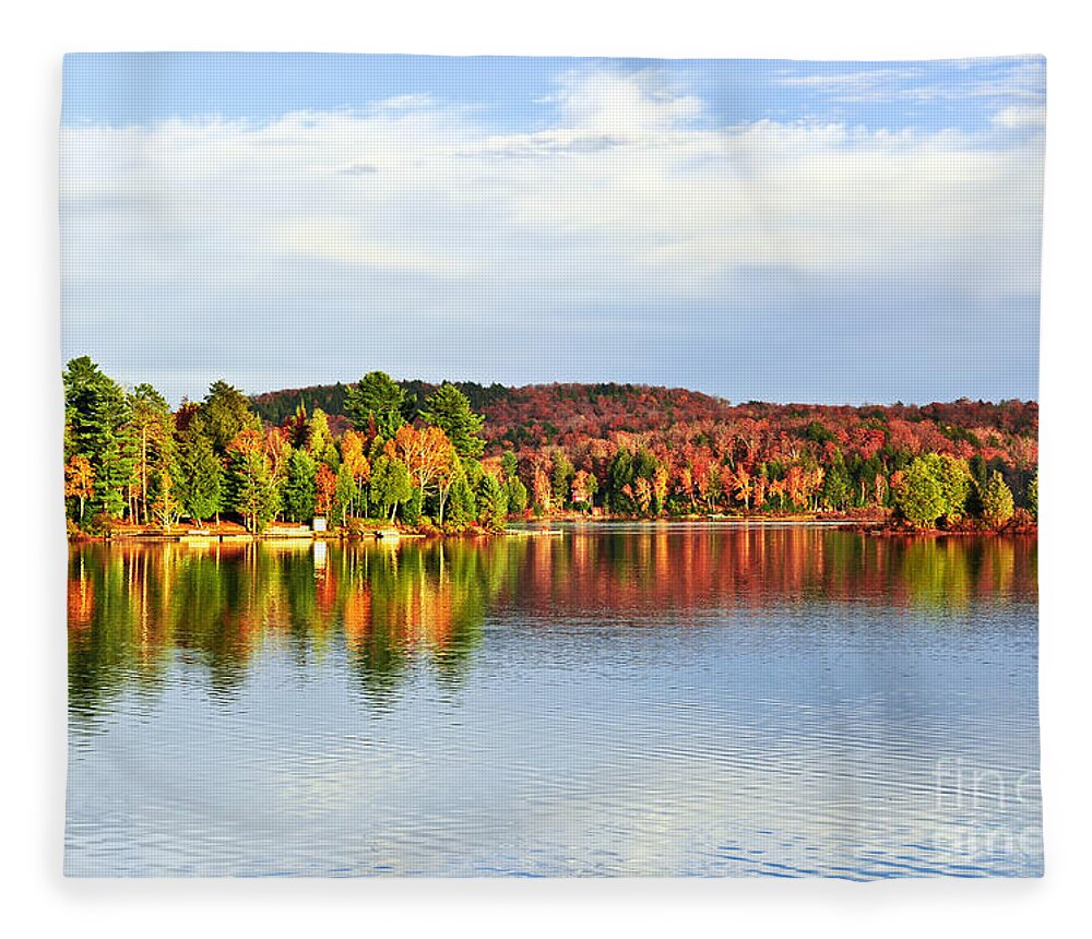Lake Fleece Blanket featuring the photograph Fall forest reflecting in lake by Elena Elisseeva