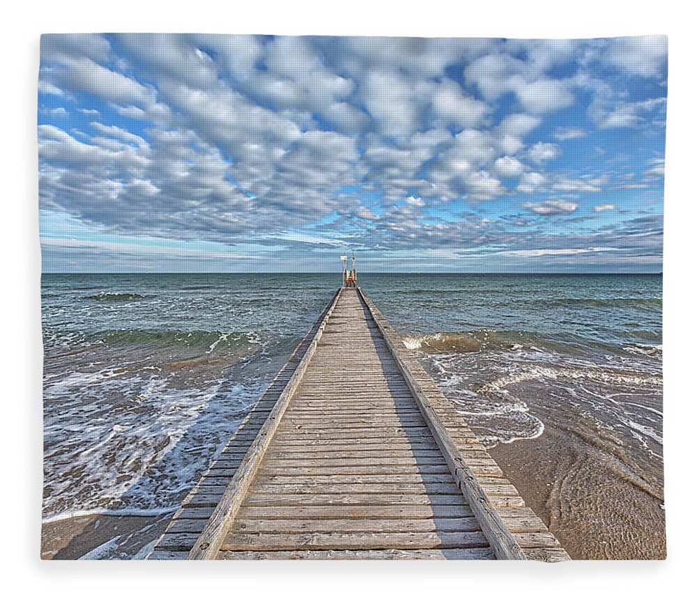 Blue Fleece Blanket featuring the photograph A dock leads to the mediterranean sea at the beach of Lido die Jesolo, Italy by Gina Koch
