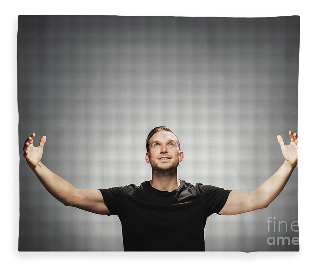 Man Fleece Blanket featuring the photograph Attractive man smiling, spreading his arms. by Michal Bednarek