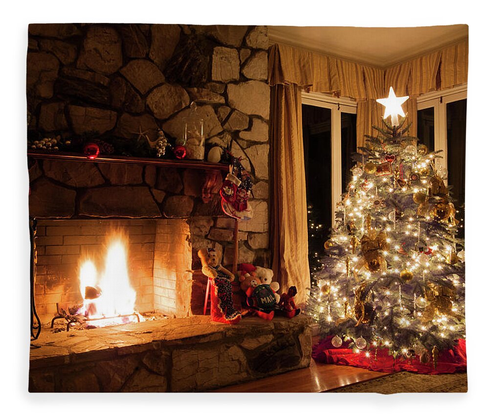 Christmas tree and rustic fireplace in a cozy home Fleece Blanket