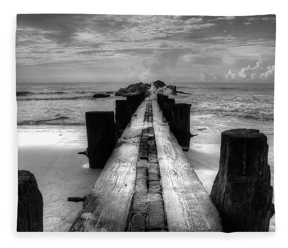 Folly Beach Pilings Fleece Blanket featuring the photograph Folly Beach Pilings Charleston South Carolina In Black and White by Carol Montoya
