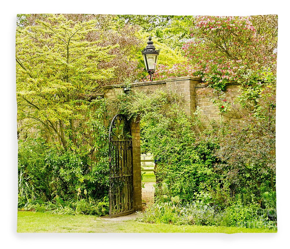 Garden Wall Fleece Blanket featuring the photograph Garden Wall With Iron Gate And Lantern. by Elena Perelman