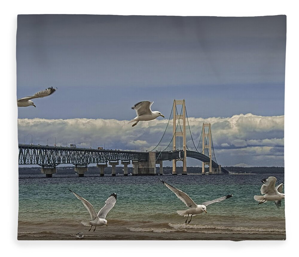 Bird Fleece Blanket featuring the photograph Gulls Flying by the Bridge at the Straits of Mackinac by Randall Nyhof