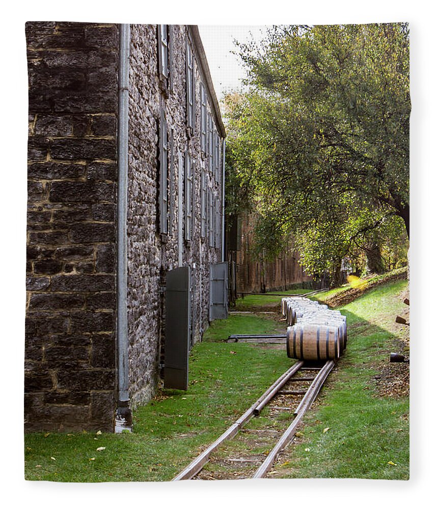 American Fleece Blanket featuring the photograph Oak barrels outside stone distillery by Karen Foley
