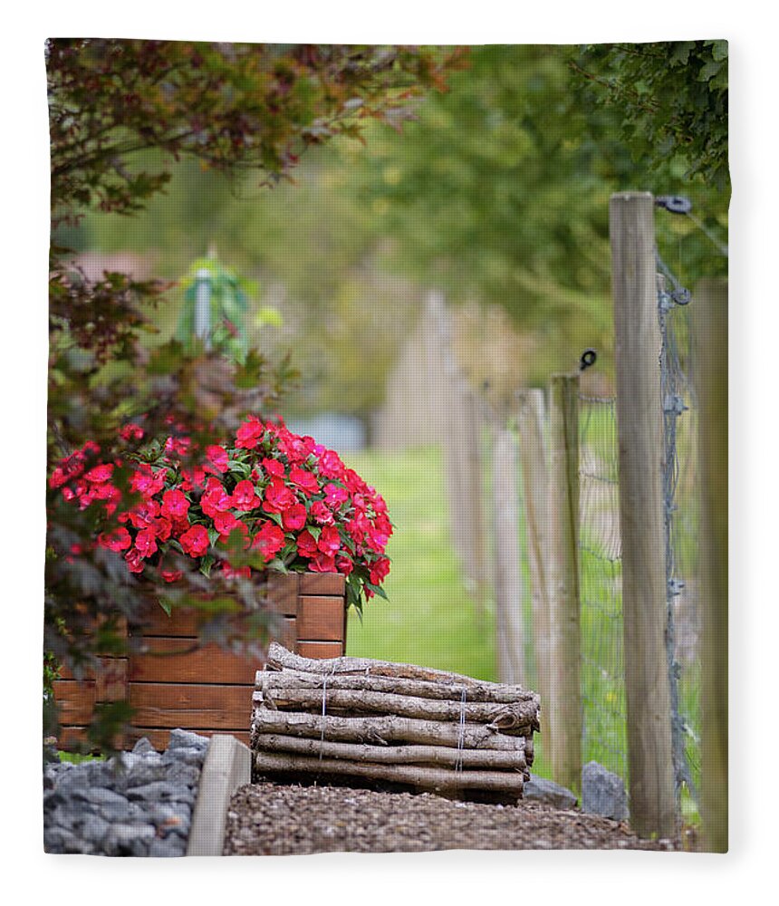 Country Fleece Blanket featuring the photograph Red flowerd with Fende and wood billet bundle by Amanda Mohler