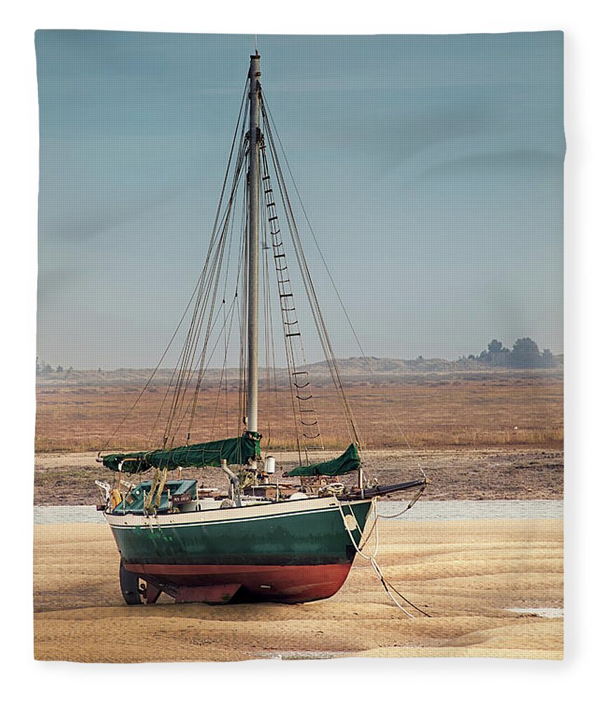 Wells Fleece Blanket featuring the photograph Norfolk sail boat stranded at low tide by Simon Bratt