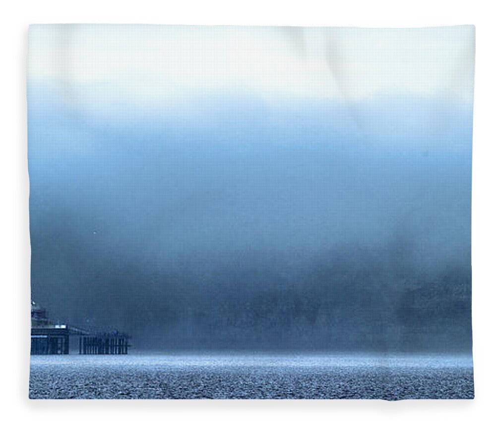 Pier Fleece Blanket featuring the photograph The sea mist lifts to reveal the Great Orme behind Llandudno Pier by Mal Bray