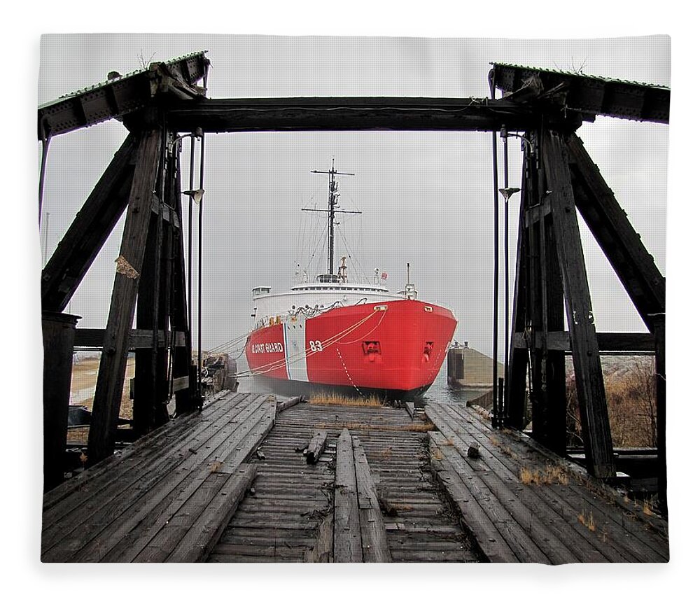 Mackinaw Fleece Blanket featuring the photograph USCGC Mackinaw framed by railroad elevator by Keith Stokes