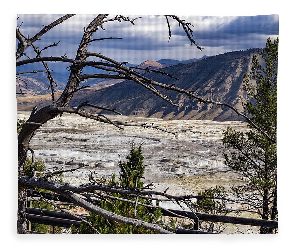 America Fleece Blanket featuring the photograph View of the travertine and mountains from the pathway at Mammoth Hot Springs by Roslyn Wilkins