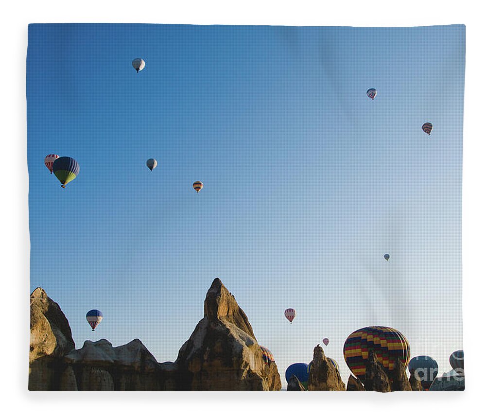 Adventure Fleece Blanket featuring the photograph Colorful balloons flying over mountains and with blue sky #5 by Joaquin Corbalan
