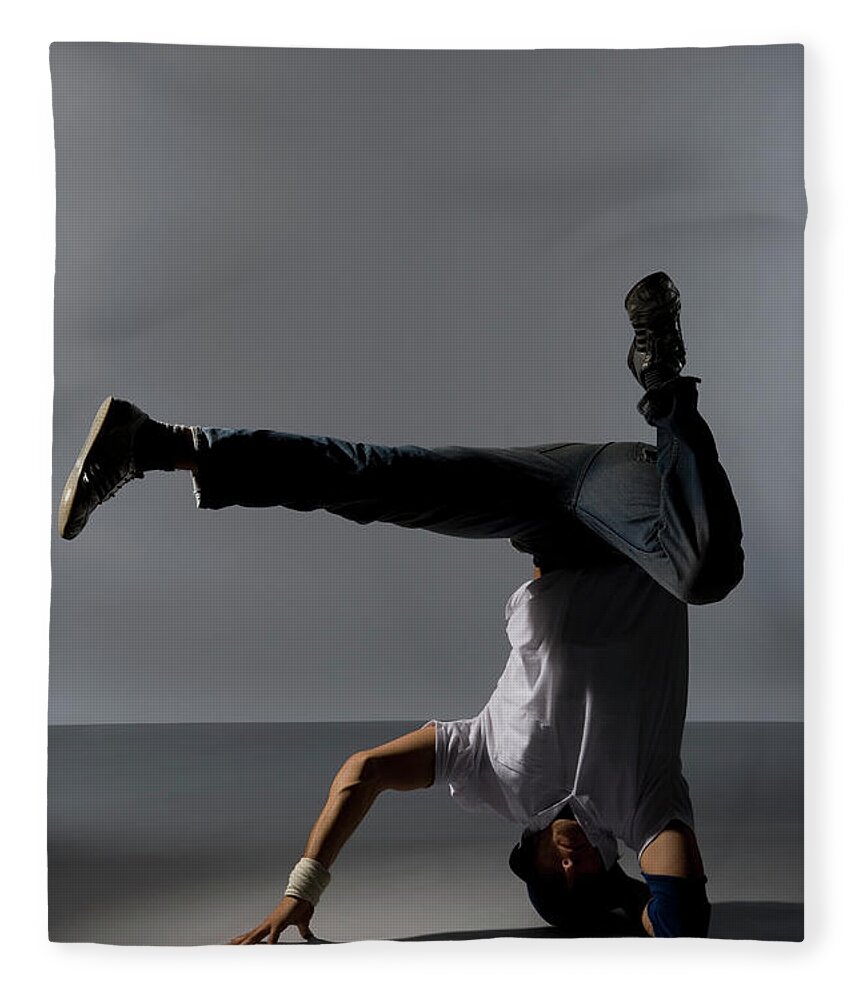Cool Attitude Fleece Blanket featuring the photograph A B-boy Doing A Headspin Freeze by Halfdark